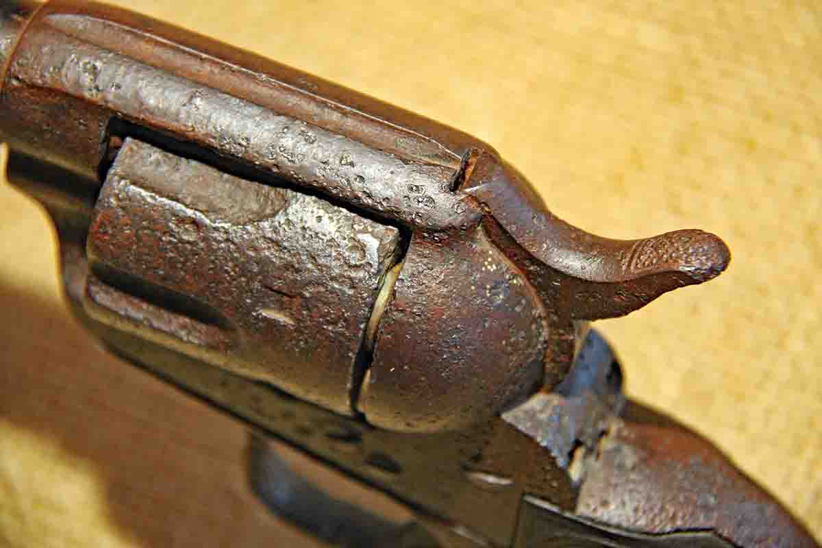 The hammer is frozen in the first click position over the second fired shell, showing that the owner was just starting to draw the hammer back to fire a third shot when the gun was dropped.